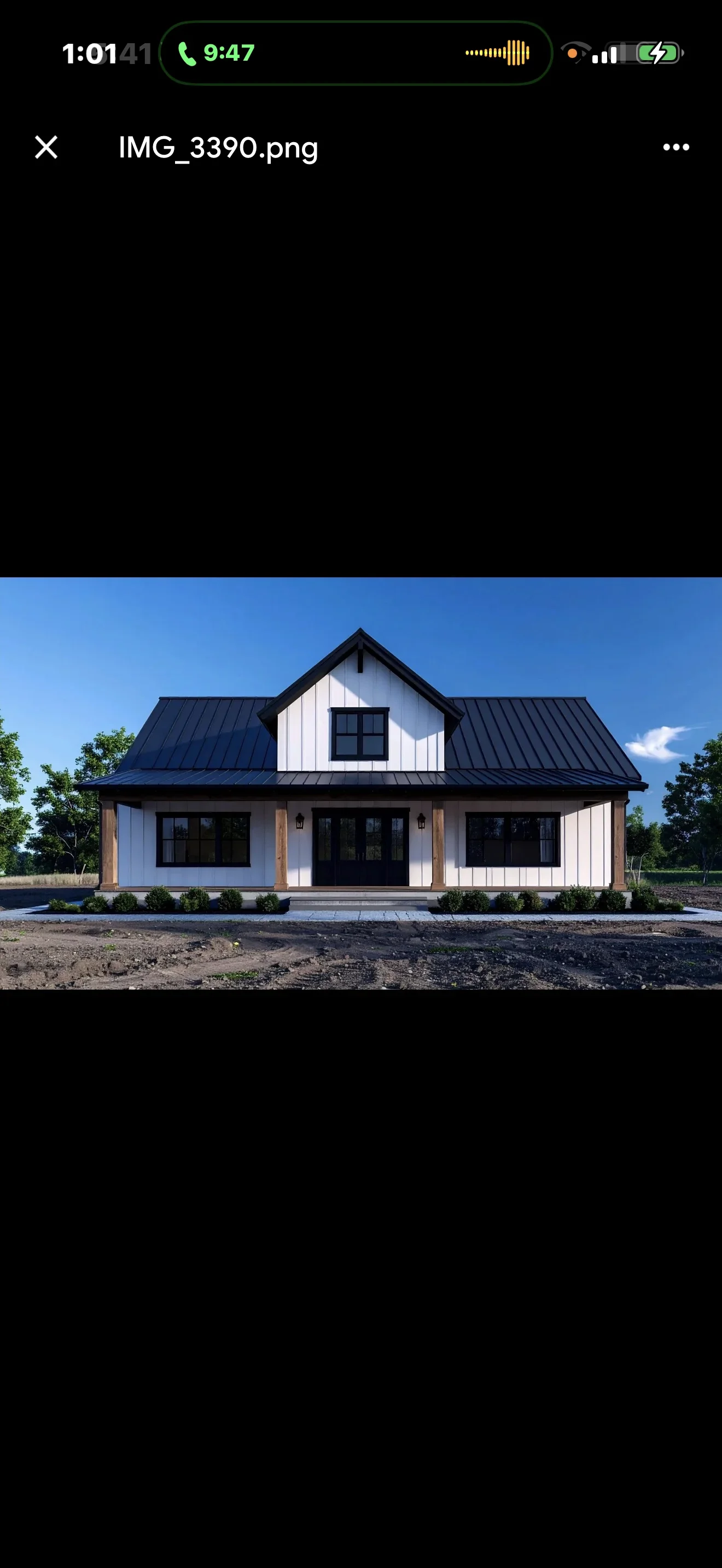 Modern farmhouse with white board-and-batten siding, black standing-seam metal roof, and wood porch columns